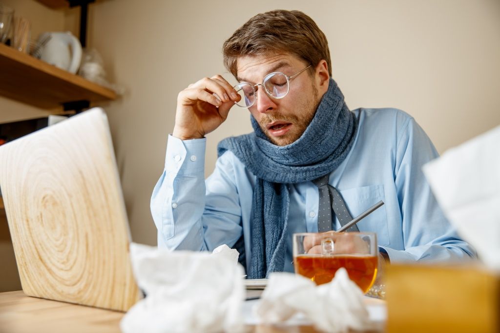 feeling-sick-tired-man-with-cup-hot-tea-working-office-businessman-caught-cold-seasonal-flu-pandemic-influenza-disease-prevention-air-conditioning-office-cause-sickness.jpg