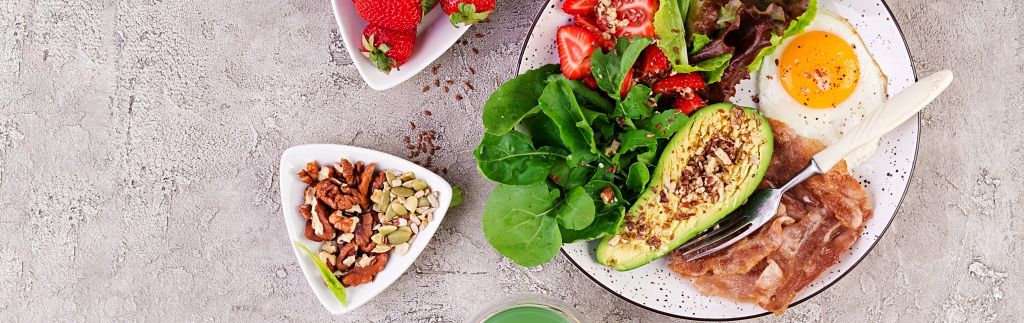 plate-with-keto-diet-food-fried-egg-bacon-avocado-arugula-strawberries-keto-breakfast-top-view.jpg